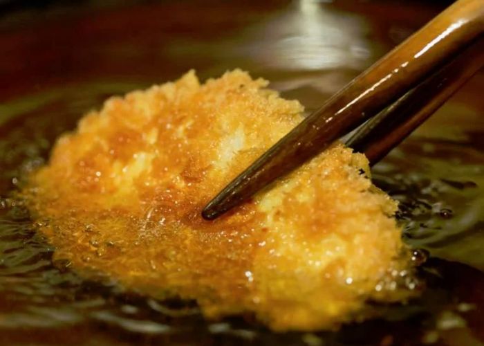 A pork cutlet being deep-fried at Kanda Ponchiken, the Michelin star tonkatsu restaurant in Tokyo.